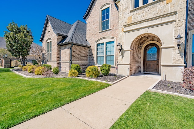 13 Kensington Dr, Heath, TX 75032 - entrance to property with brick siding, a lawn, and stone siding