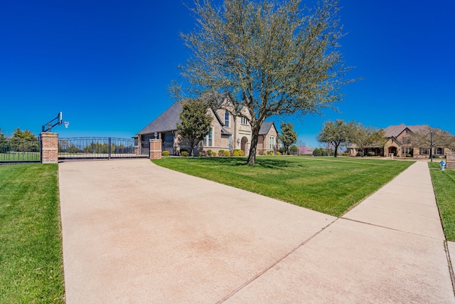 13 Kensington Dr, Heath, TX 75032 - view of front of house with brick siding, a gate, and driveway