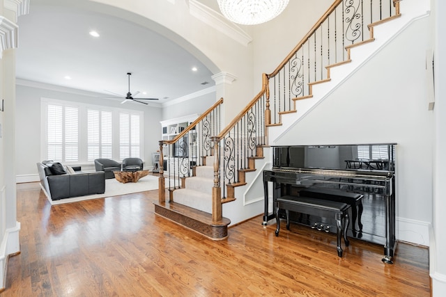13 Kensington Dr, Heath, TX 75032 - staircase featuring arched walkways, ornamental molding, ceiling fan, wood finished floors, and recessed lighting