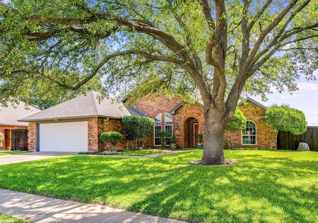 10253 Fieldcrest Dr, Benbrook, TX 76126 - view of front of property featuring a front lawn, an attached garage, brick siding, a shingled roof, and concrete driveway