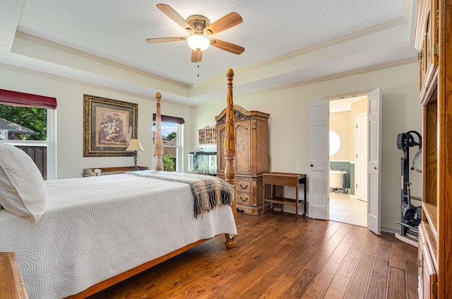10253 Fieldcrest Dr, Benbrook, TX 76126 - bedroom featuring multiple windows, ornamental molding, hardwood / wood-style flooring, a raised ceiling, and connected bathroom