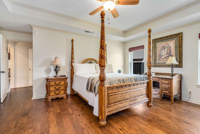 10253 Fieldcrest Dr, Benbrook, TX 76126 - bedroom featuring a tray ceiling, crown molding, wood finished floors, a textured ceiling, and baseboards