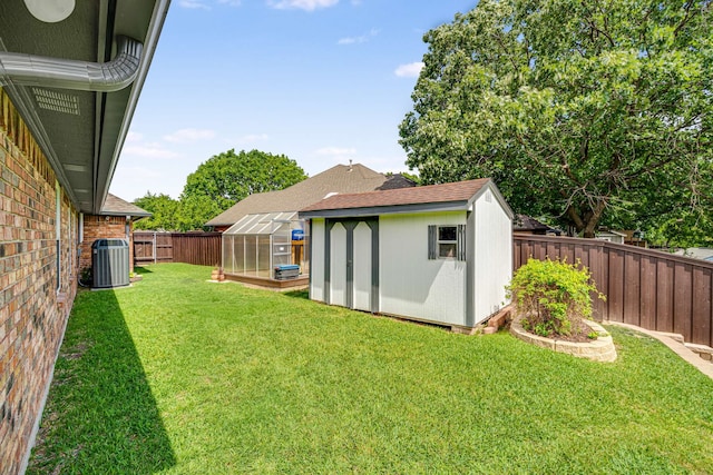 10253 Fieldcrest Dr, Benbrook, TX 76126 - view of yard with a greenhouse, an outbuilding, and central air condition unit