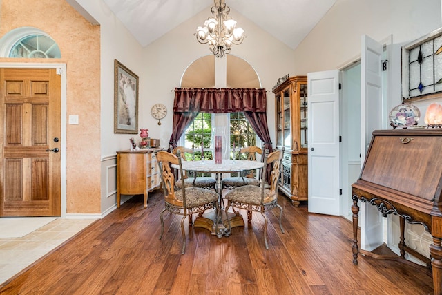 10253 Fieldcrest Dr, Benbrook, TX 76126 - dining area with a chandelier, wood finished floors, and high vaulted ceiling