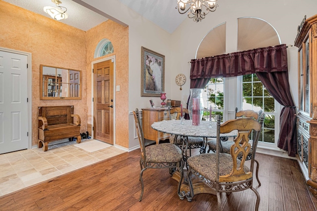 10253 Fieldcrest Dr, Benbrook, TX 76126 - dining room featuring light wood-style floors, a chandelier, high vaulted ceiling, and baseboards
