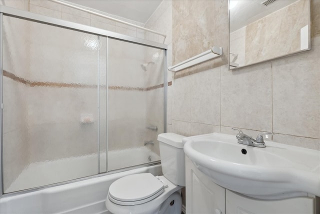 5629 Farnsworth Ave, Fort Worth, TX 76107 - full bathroom with tile walls, bath / shower combo with glass door, toilet, vanity, and tasteful backsplash
