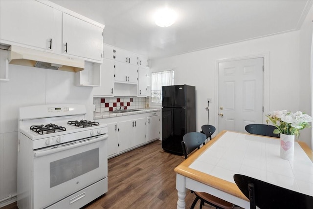 5629 Farnsworth Ave, Fort Worth, TX 76107 - kitchen with white gas stove, freestanding refrigerator, under cabinet range hood, a sink, and dark wood-style floors