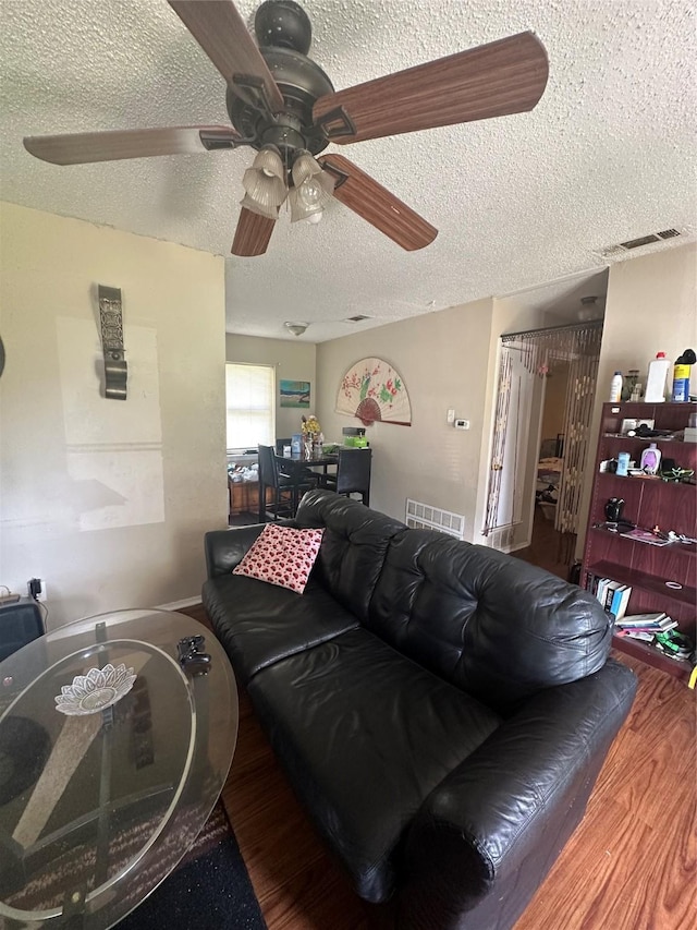 1330 Eastern Heights Dr, Mesquite, TX 75149 - living room featuring wood finished floors, a textured ceiling, and ceiling fan