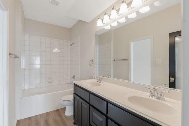 1928 Argyle Ln, Lewisville, TX 75067 - full bath with wood finished floors, double vanity, toilet, and bathtub / shower combination