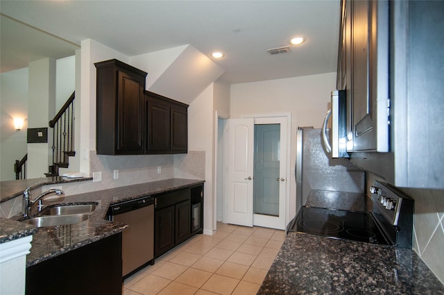 1928 Argyle Ln, Lewisville, TX 75067 - kitchen with stainless steel appliances, a sink, dark stone countertops, tasteful backsplash, and light tile patterned flooring