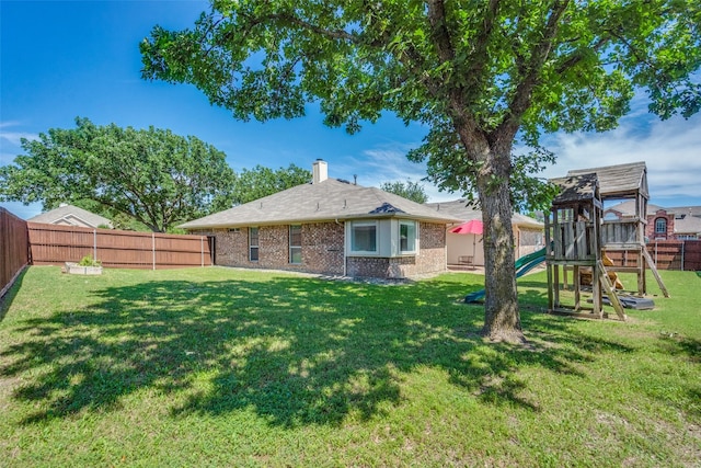 501 Tealwood Dr, Murphy, TX 75094 - rear view of house featuring a playground, brick siding, and a chimney