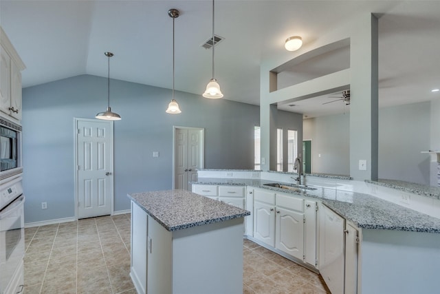 501 Tealwood Dr, Murphy, TX 75094 - kitchen featuring a sink, white oven, ceiling fan, white cabinets, and vaulted ceiling