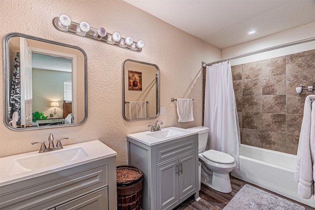 400 Rs County Road 3130, Emory, TX 75440 - bathroom with wood finished floors, two vanities, toilet, shower / tub combo with curtain, and a textured wall