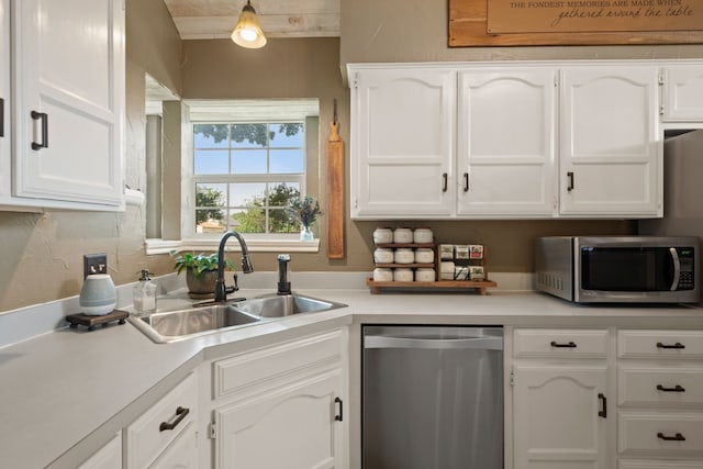 7600 Teresa Ct, North Richland Hills, TX 76182 - kitchen with appliances with stainless steel finishes, a sink, white cabinetry, and light countertops