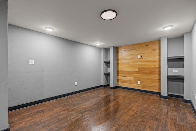511 Mcfarland Ranch Rd, Aledo, TX 76008 - spare room with dark wood-type flooring, baseboards, and wood walls