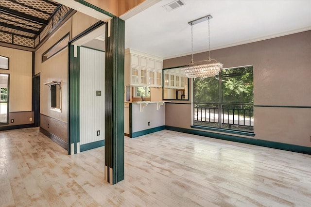 4291 County Road 862, Mckinney, TX 75071 - unfurnished room featuring healthy amount of natural light, a chandelier, light wood finished floors, baseboards, and ornamental molding