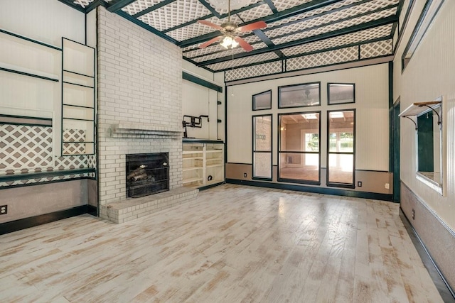 4291 County Road 862, Mckinney, TX 75071 - unfurnished living room with wood finished floors, a ceiling fan, plenty of natural light, and a brick fireplace