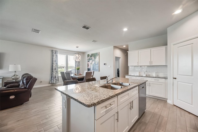 9700 Serviceberry Ln, Fort Worth, TX 76036 - kitchen featuring dishwasher, open floor plan, a sink, light wood-style floors, and recessed lighting