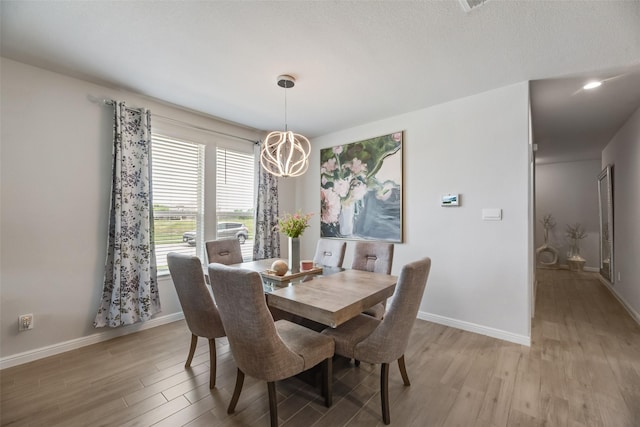 9700 Serviceberry Ln, Fort Worth, TX 76036 - dining area with light wood-style flooring, baseboards, and a chandelier