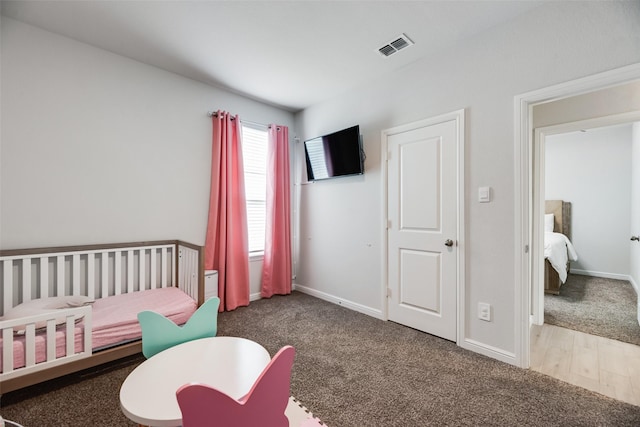 9700 Serviceberry Ln, Fort Worth, TX 76036 - bedroom featuring a crib, carpet flooring, baseboards, and wood finished floors