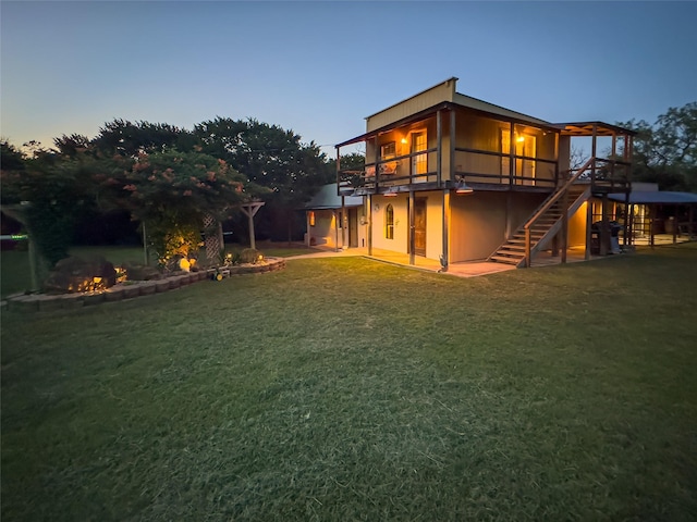 801 Prachyl Rd, Weatherford, TX 76087 - back of property at dusk featuring stairway, a yard, and a wooden deck