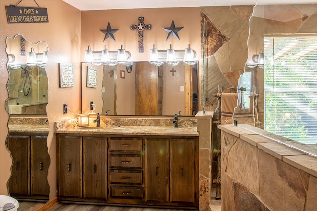 801 Prachyl Rd, Weatherford, TX 76087 - full bathroom with double vanity, a tile shower, and wood finished floors