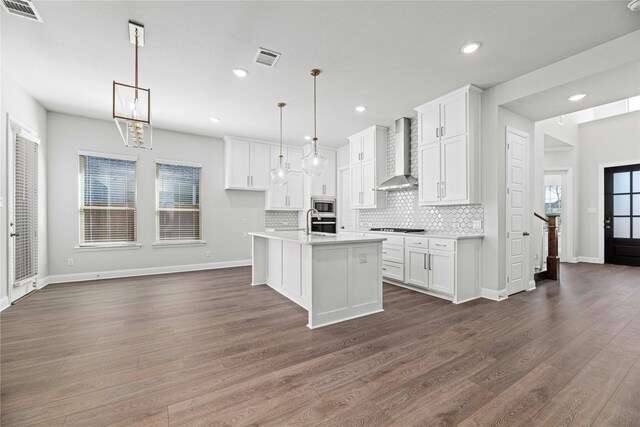 16532 Dunkirk Ln, Frisco, TX 75035 - kitchen featuring wall chimney exhaust hood, appliances with stainless steel finishes, backsplash, white cabinets, and light countertops