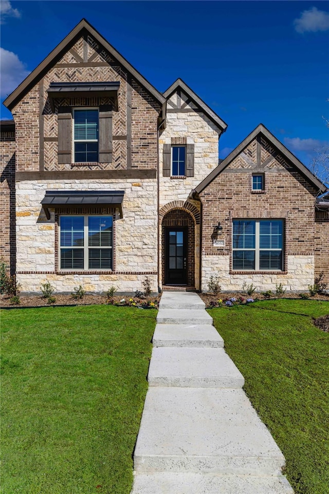 16532 Dunkirk Ln, Frisco, TX 75035 - french country inspired facade with a front yard, brick siding, and stone siding