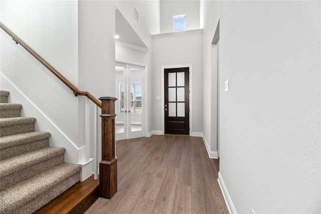16532 Dunkirk Ln, Frisco, TX 75035 - foyer featuring wood finished floors, stairs, baseboards, plenty of natural light, and a towering ceiling