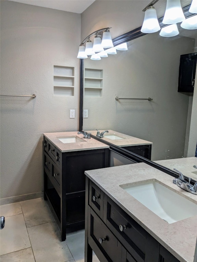 7525 Holly Hill Dr Unit 68, Dallas, TX 75231 - bathroom with two vanities, tile patterned floors, and baseboards