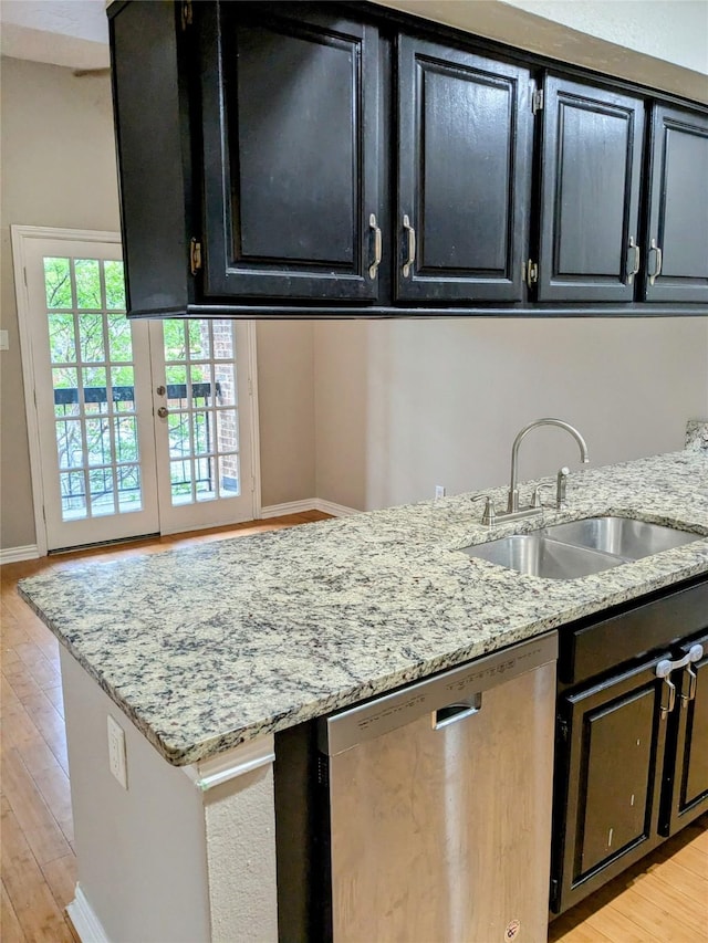 7525 Holly Hill Dr Unit 68, Dallas, TX 75231 - kitchen featuring dishwasher, dark cabinetry, a sink, and baseboards