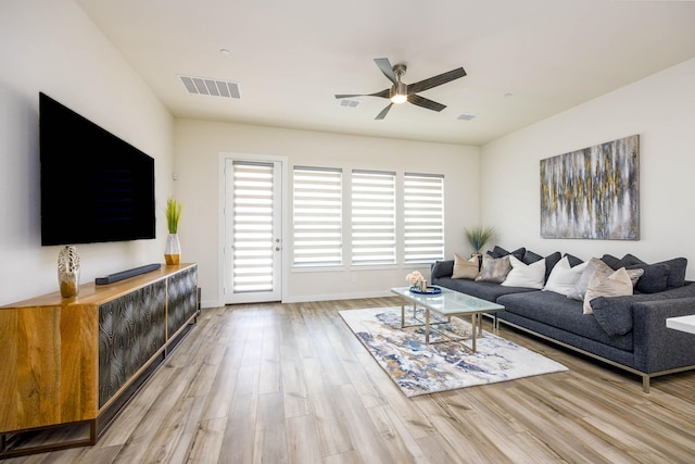 2734 Levee Ln, Lewisville, TX 75067 - living area with a ceiling fan, light wood-type flooring, and baseboards