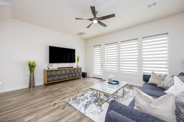 2734 Levee Ln, Lewisville, TX 75067 - living room with a ceiling fan, wood finished floors, and baseboards