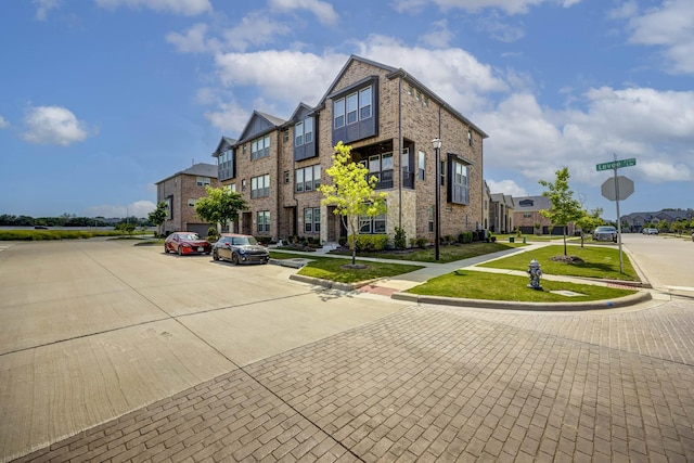 2734 Levee Ln, Lewisville, TX 75067 - view of building exterior featuring uncovered parking and a residential view