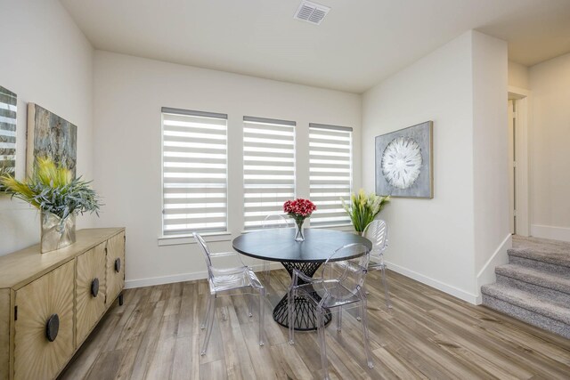 2734 Levee Ln, Lewisville, TX 75067 - dining area featuring light wood-style floors, baseboards, and stairway