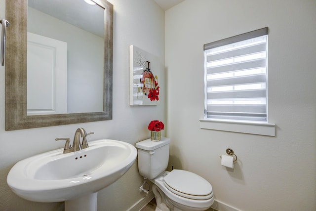 2734 Levee Ln, Lewisville, TX 75067 - bathroom with baseboards, a sink, and toilet