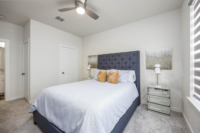 2734 Levee Ln, Lewisville, TX 75067 - carpeted bedroom with baseboards, ceiling fan, and ensuite bathroom
