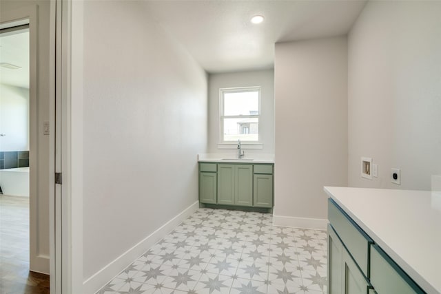 9900 Aiken Ct, Mesquite, TX 75126 - laundry room with light flooring, washer hookup, electric dryer hookup, baseboards, and cabinet space
