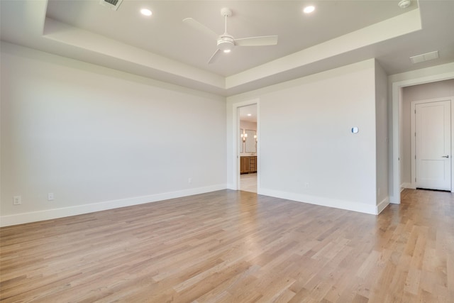 9900 Aiken Ct, Mesquite, TX 75126 - unfurnished room featuring a tray ceiling, light wood-style flooring, baseboards, a ceiling fan, and recessed lighting