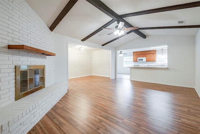 4313 Barcelona Dr, Fort Worth, TX 76133 - unfurnished living room featuring a ceiling fan, a brick fireplace, light wood-style flooring, and baseboards