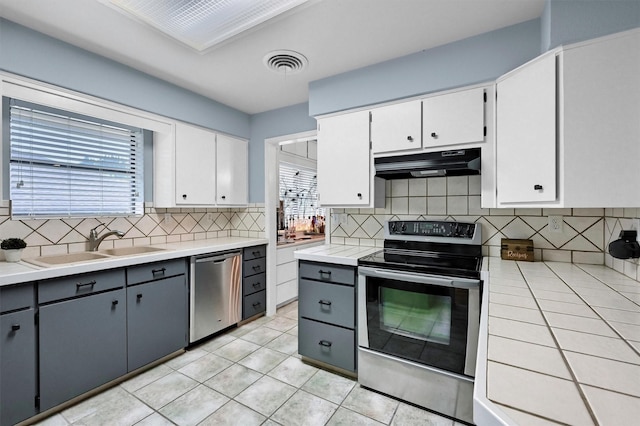 116 Modoc Trl, Lake Kiowa, TX 76240 - kitchen with appliances with stainless steel finishes, under cabinet range hood, a sink, decorative backsplash, and white cabinets
