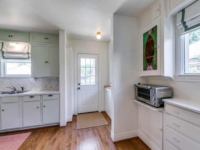 819 Clermont Ave, Dallas, TX 75223 - kitchen featuring a sink, healthy amount of natural light, light wood-style flooring, and light countertops
