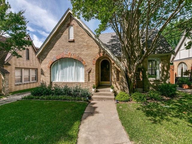 819 Clermont Ave, Dallas, TX 75223 - tudor house with brick siding and a front lawn