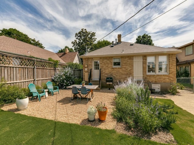 819 Clermont Ave, Dallas, TX 75223 - rear view of property featuring brick siding and a patio area