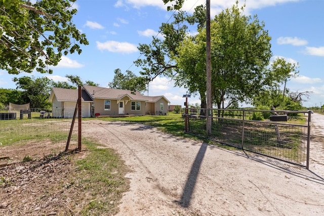 105 S Lavaca St, Whitney, TX 76692 - ranch-style home with dirt driveway, a gate, and a garage