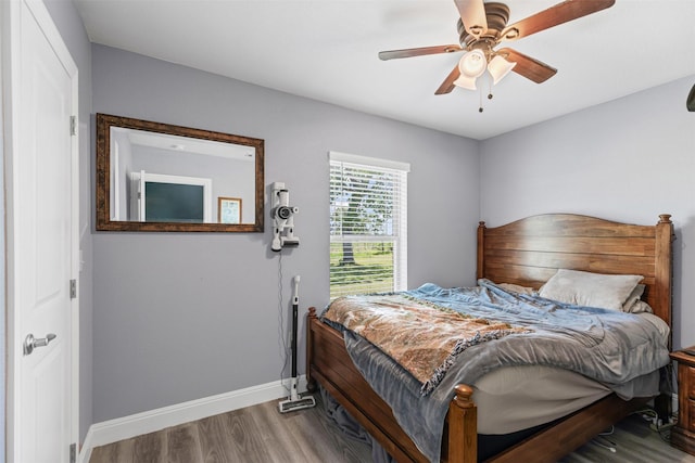 105 S Lavaca St, Whitney, TX 76692 - bedroom with wood finished floors, baseboards, and ceiling fan