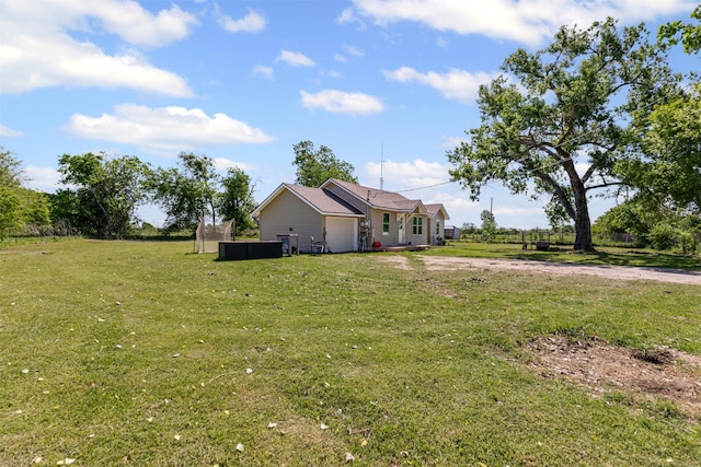 105 S Lavaca St, Whitney, TX 76692 - view of green lawn with a garage and dirt driveway