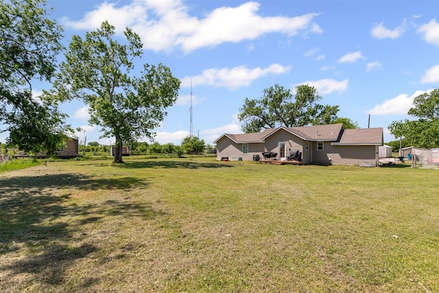 105 S Lavaca St, Whitney, TX 76692 - view of grassy yard featuring a wooden deck