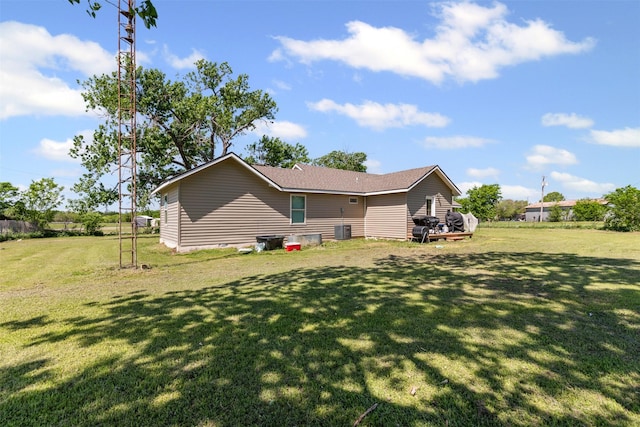 105 S Lavaca St, Whitney, TX 76692 - rear view of property with a yard and central air condition unit
