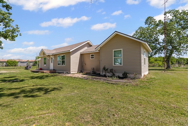 105 S Lavaca St, Whitney, TX 76692 - rear view of house featuring a yard and roof with shingles